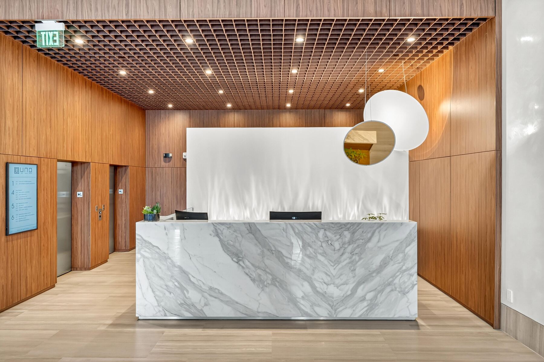 Uno House office lobby with marble reception desk built by AMDI